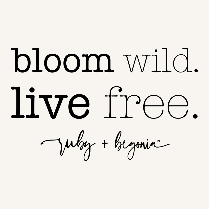 Motivational quote 'bloom wild. live free.' with brand name 'ruby + begonia' on a white background.