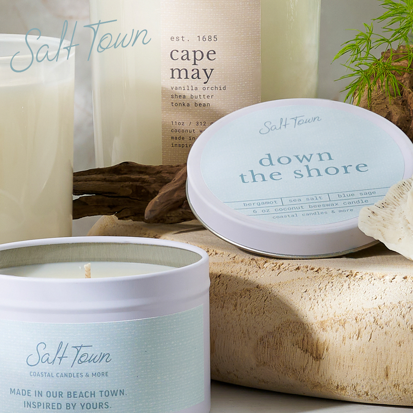 Salt Town candles and containers on a wooden surface with natural elements.